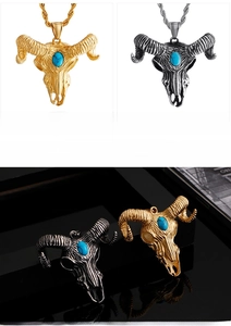 Detail of goat skull pendant with turquoise stone inlay in gold and silver finishes