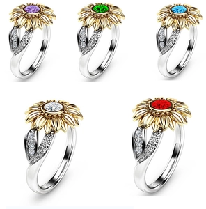 Detail of sunflower rings set with colorful stones in purple, green, blue, white, and red