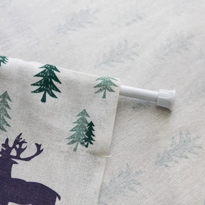 Linen door curtain with deer and pine tree print featuring a rod pocket design