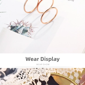 Detailed view of three-piece 1mm rose gold ultra-thin stacking rings on white lace