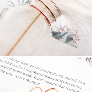 Detailed view of 1mm colorful enamel rings in red, black, and white on a vintage book