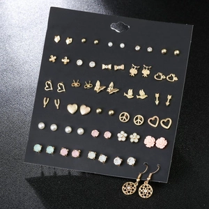 Detailed view of assorted colorful zircon stud earrings on black display card