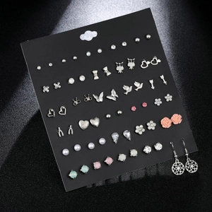 Detailed view of assorted heart and bow stud earring set with zircons on a display card