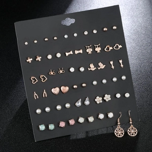 Detailed set of 30 pairs of stud earrings featuring hearts, bows and pearls on a card