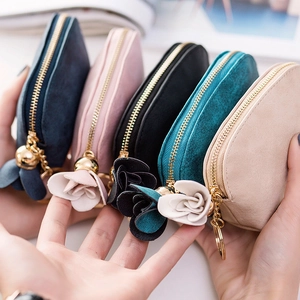 Suede coin purses in multiple colors with flower tassels and gold zippers