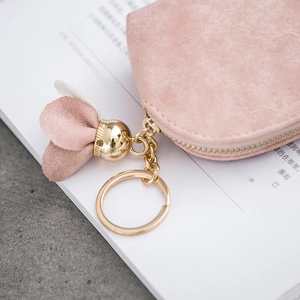 Pink matte dumpling coin purse with gold zipper and decorative floral keychain tassel