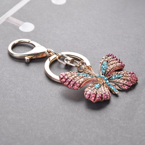 Sparkling butterfly keychain with pink and blue crystals on a golden alloy ring