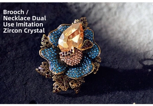 Macro shot of luxury floral brooch featuring blue crystals and champagne drop gemstone