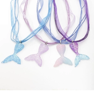 Detail view of colorful gradient mermaid tail necklaces with ribbon and wax cords