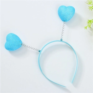 Close-up of blue glitter heart headband with flexible metal springs and plastic frame
