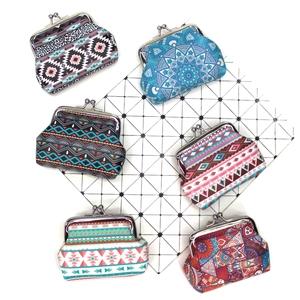 Close-up of vintage kiss-lock coin purses with diverse ethnic canvas floral patterns