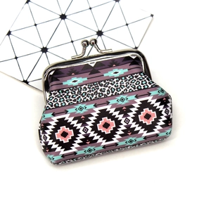 Detail of vintage bohemian coin purse with leopard print and classic metal clasp closure
