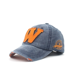 Close-up of vintage washed denim baseball cap with orange W patch and side embroidery
