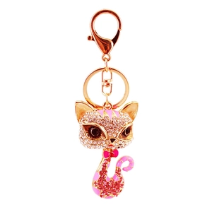 Sparkling pink rhinestone cat keychain with rose gold alloy base on white background