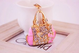 Detail of pink floral handbag keychain charm with gold plating and sparkling crystals