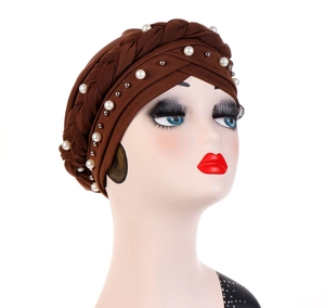 Detail of brown milk silk turban cap featuring braided trim and white pearl embellishments
