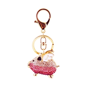 Sparkling pink rhinestone pig keychain with golden wings and polished metal hook charm