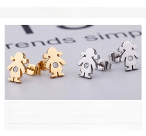 Detail view of gold and silver girl-shaped stud earrings in 18K plated stainless steel