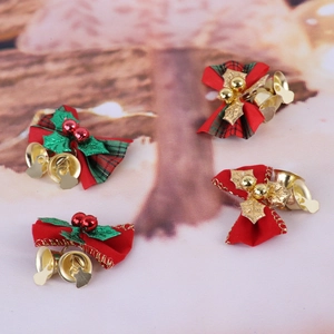 Detailed view of red and green plaid Christmas bows with small gold metal bells