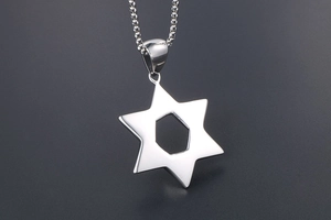 Detail of vintage hollow hexagram pendant on round bead chain in silver stainless steel