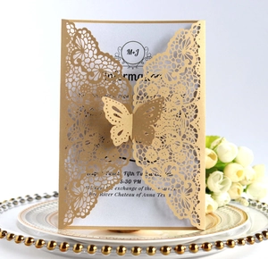 Detailed view of hollow butterfly wedding invitation in gold with elegant laser-cut patterns