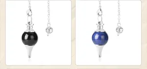 Macro view of crystal pendulum pendants in black obsidian and blue lapis lazuli