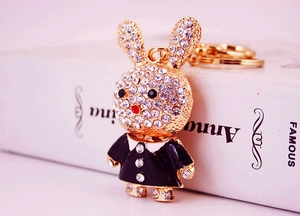 Close-up of golden bunny keychain featuring sparkling rhinestones and black outfit detail