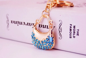 Detail of light blue rhinestone handbag keychain with gold metal lobster clasp