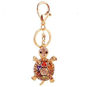 Golden sea turtle keychain with colorful rhinestones on a polished metal ring and hook