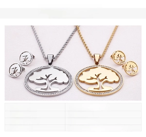 Macro detail of tree of life jewelry set in 18K gold plated and stainless steel finish