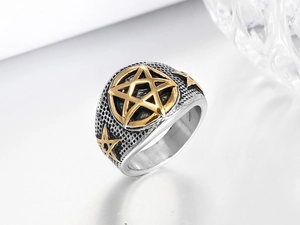 Detail of vintage punk star ring featuring brushed steel texture and gold accents