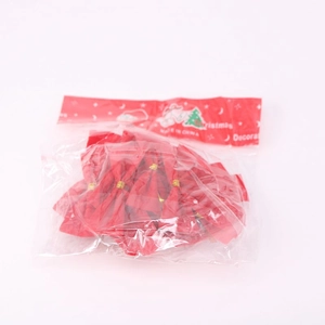 Detail of red Christmas tree bows in clear packaging with gold twist ties for decoration