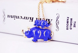 Detailed view of blue rhinoceros keychain with gold plating and sparkling rhinestones