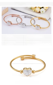 Detail showing heart charm dimensions and 59mm diameter of this woven steel wire bracelet