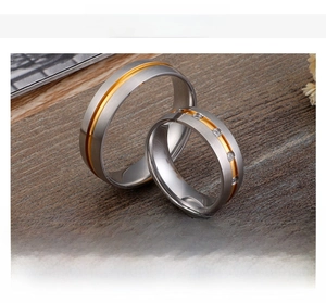 Detail of matte titanium steel rings with gold inlay and small inset diamonds