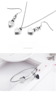 Detailed view of heart-shaped titanium steel jewelry set with black and white inlay