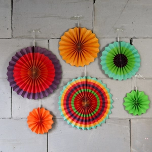 Detailed view of colorful paper fan decorations with assorted patterns and hanging strings