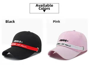 Detail of cotton baseball caps with letter embroidery, ribbons and metal ring accents
