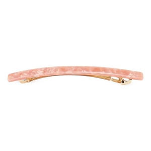 Detailed view of peach acetate hair clip with marble texture and golden metal spring