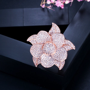 Detailed macro view of a rose gold flower brooch paved with shimmering AAA cubic zirconia crystals