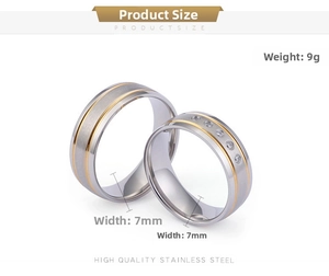 Detailed view of 7mm brushed stainless steel wedding rings with gold accents and cubic zirconia