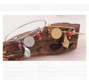 Detail of gold and steel adjustable bracelets with I Love You charms and 18K plating