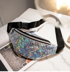 Detail of silver laser sequin waist bag with adjustable strap on marble background