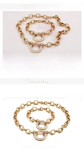 Macro detail of 18K gold plated thick chain necklace with crystal pavé circle pendant