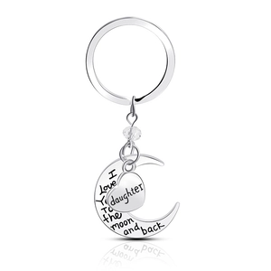 Detail of silver moon and heart keychain with engraved I Love You To The Moon and Back message