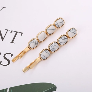 Elegant gold oval hair clips with white marble texture blocks for women in a pair