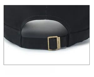 Detail of adjustable metal buckle on black cotton baseball cap for a custom fit