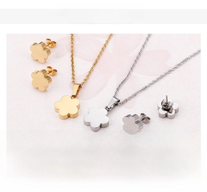 Detail view of flower jewelry set in gold and steel finish with 18K gold plating