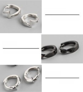 Macro details of polished S925 sterling silver hoop earrings with geometric lightning shapes