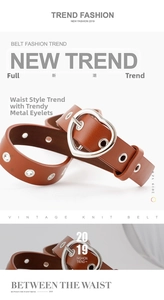 Brown leather belt featuring heart-shaped silver buckle and metallic eyelet details